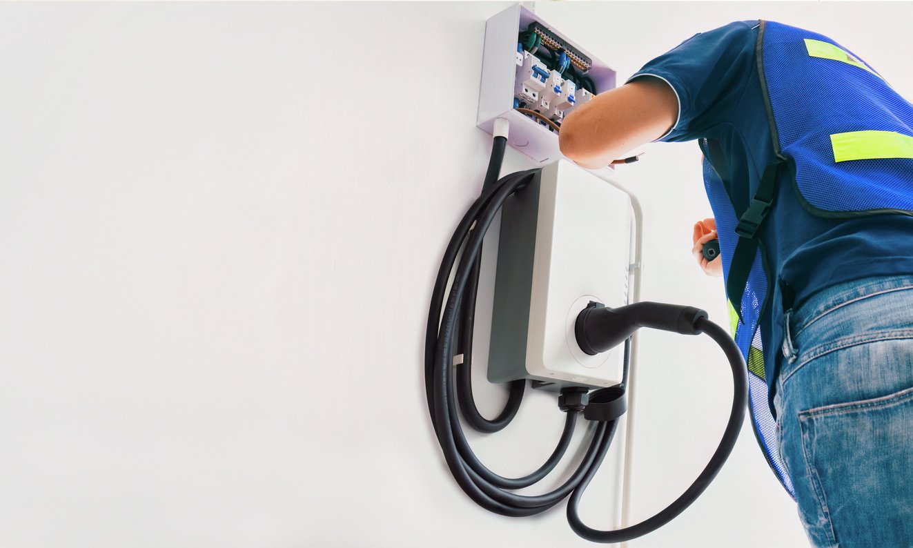 Certified male Electrician Installing Home EV Charger